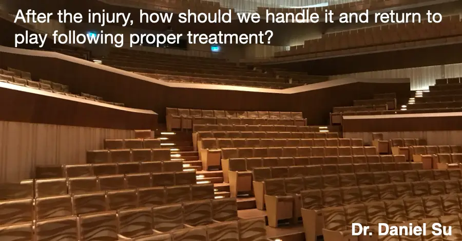 An empty concert hall seen from the stage, rows of seats lit from the side